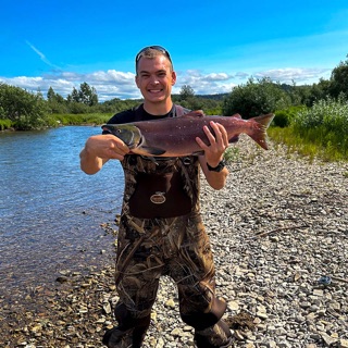 Chris holding his first salmon at Legend Lodge