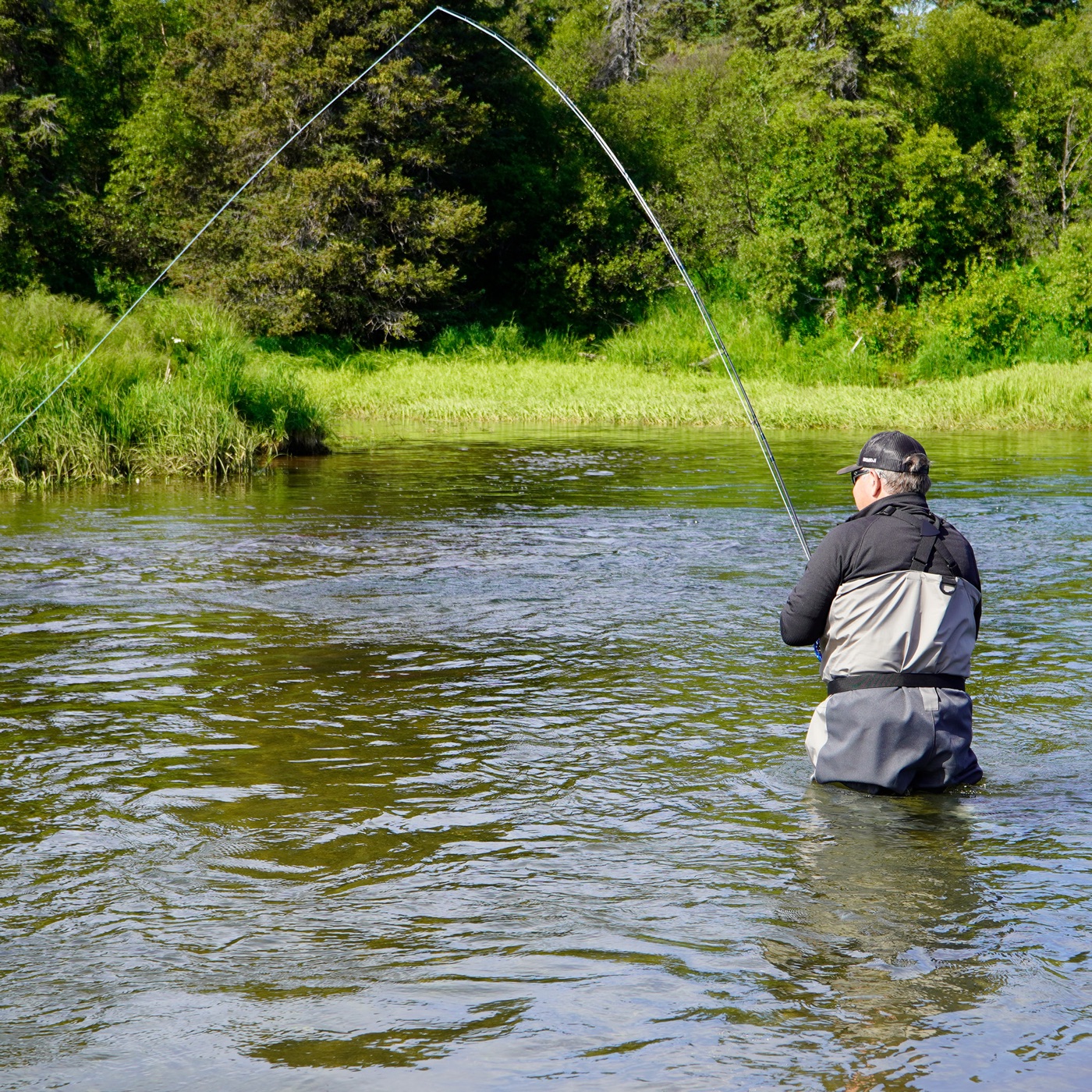 Fly angler with a bent rod on the Copper River