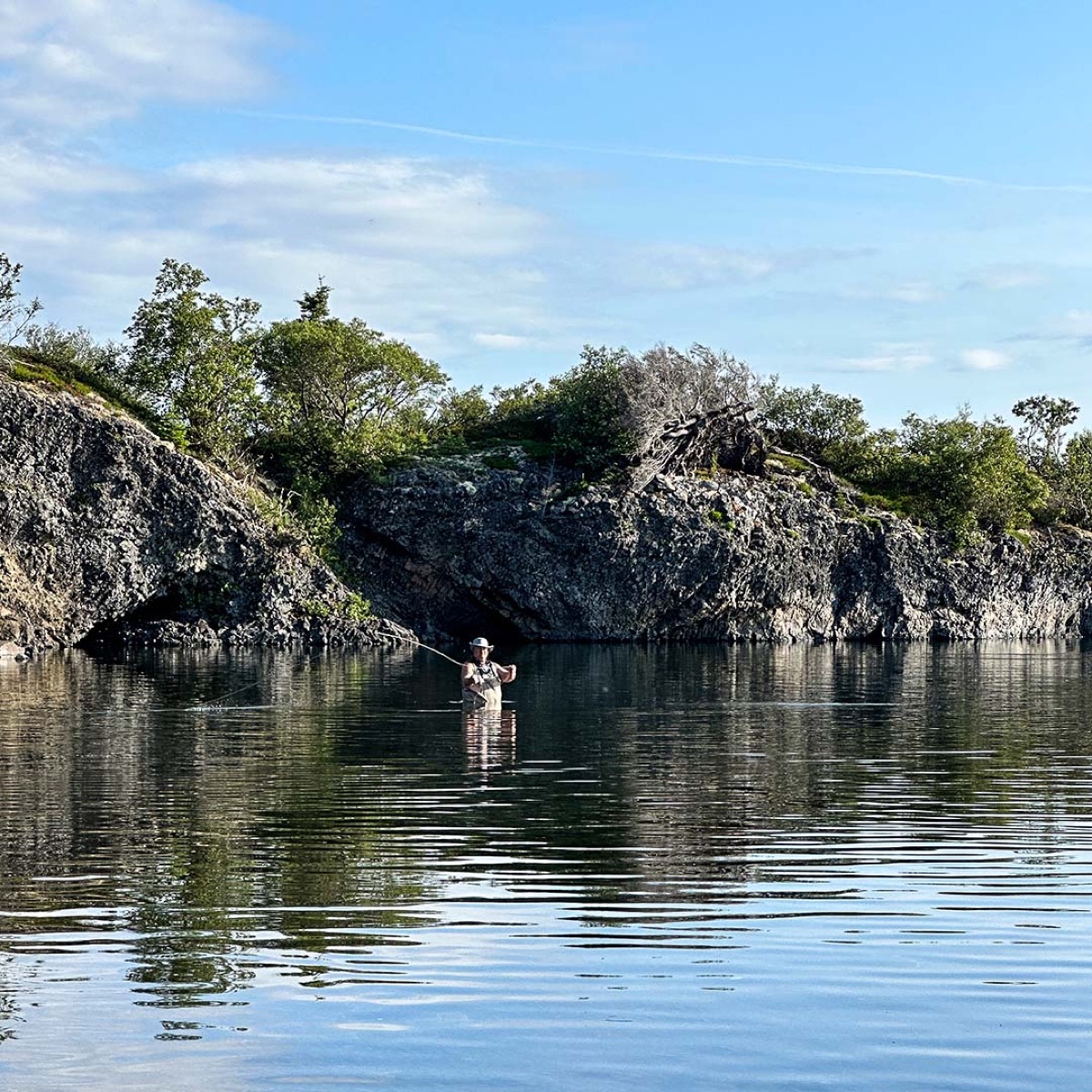 Kevin fly fishing from a rocky shore